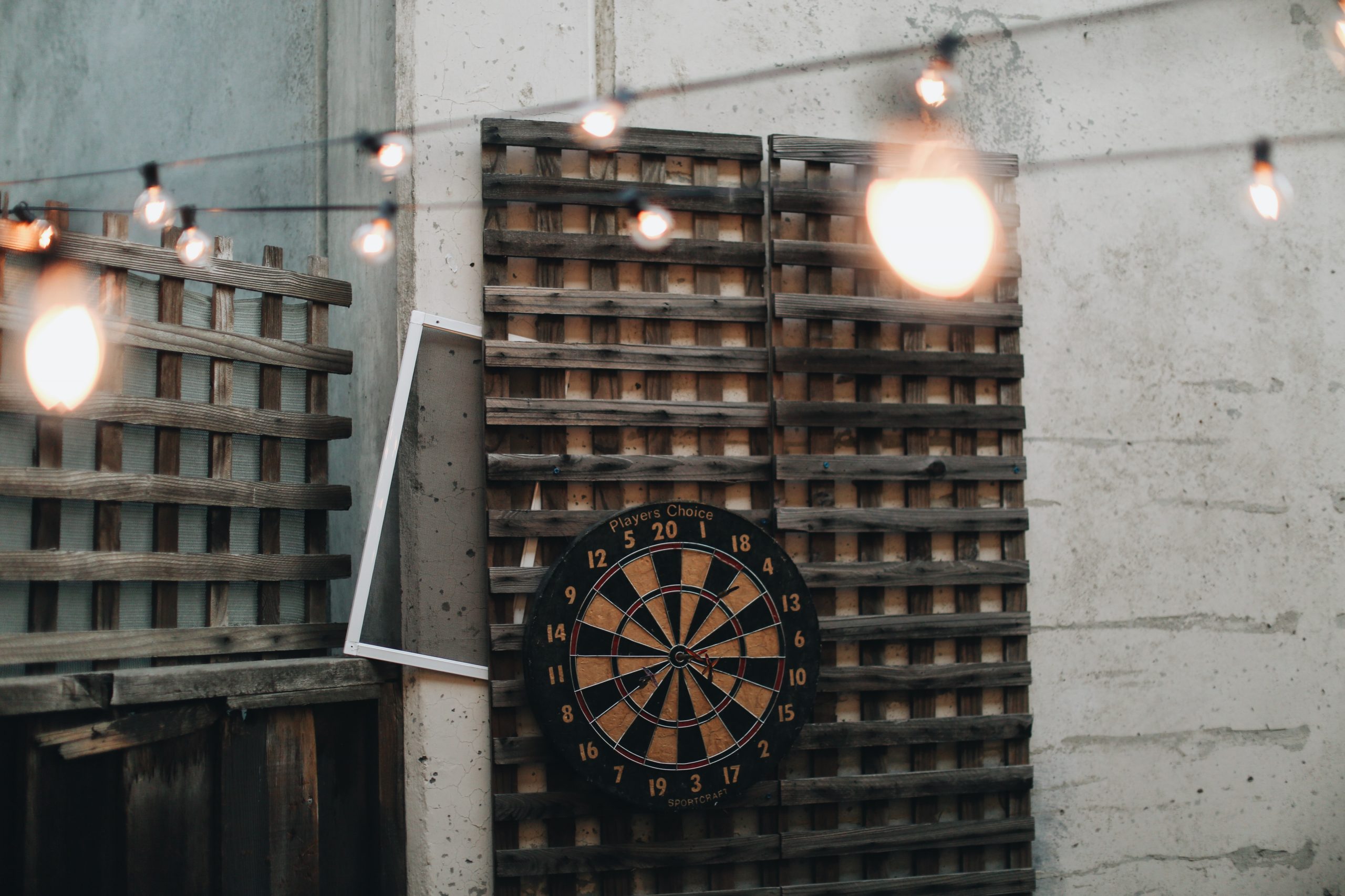 dartboard hanging on a wooden backing